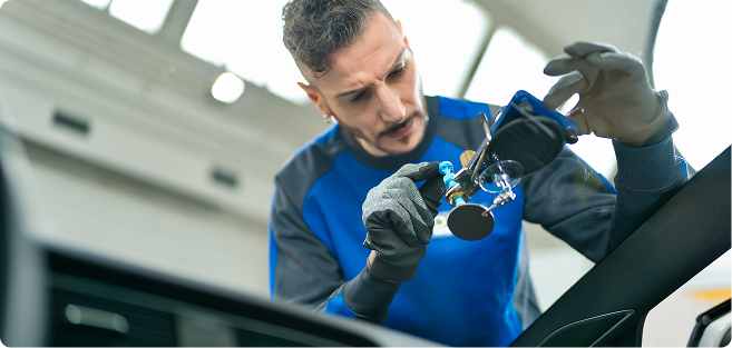 Man wiping car windshield
